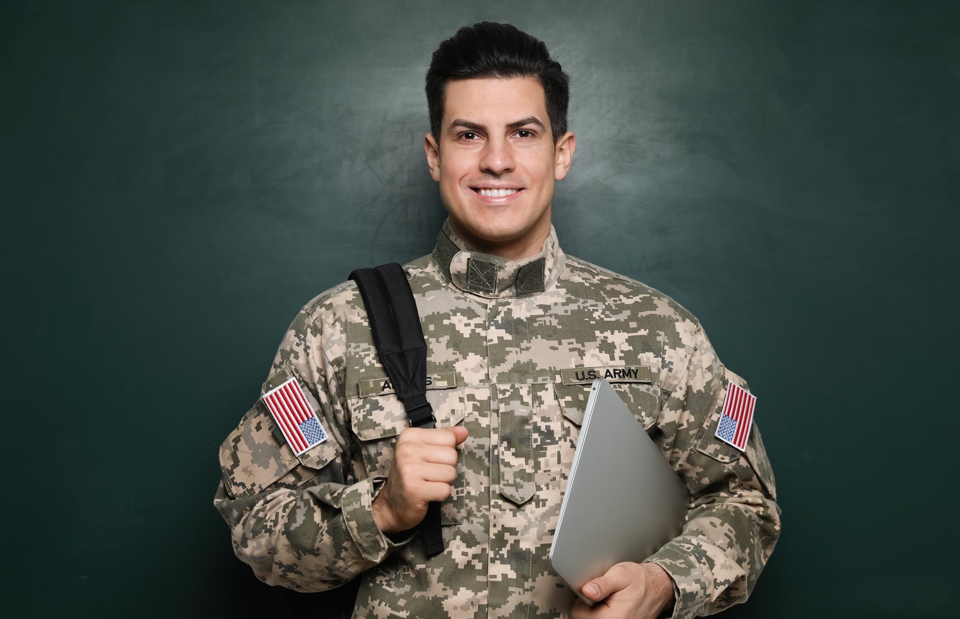 Cadet with Backpack and Laptop near Chalkboard. Military Educati