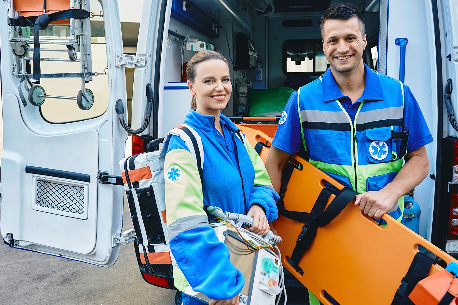 Paramedics carrying equipment